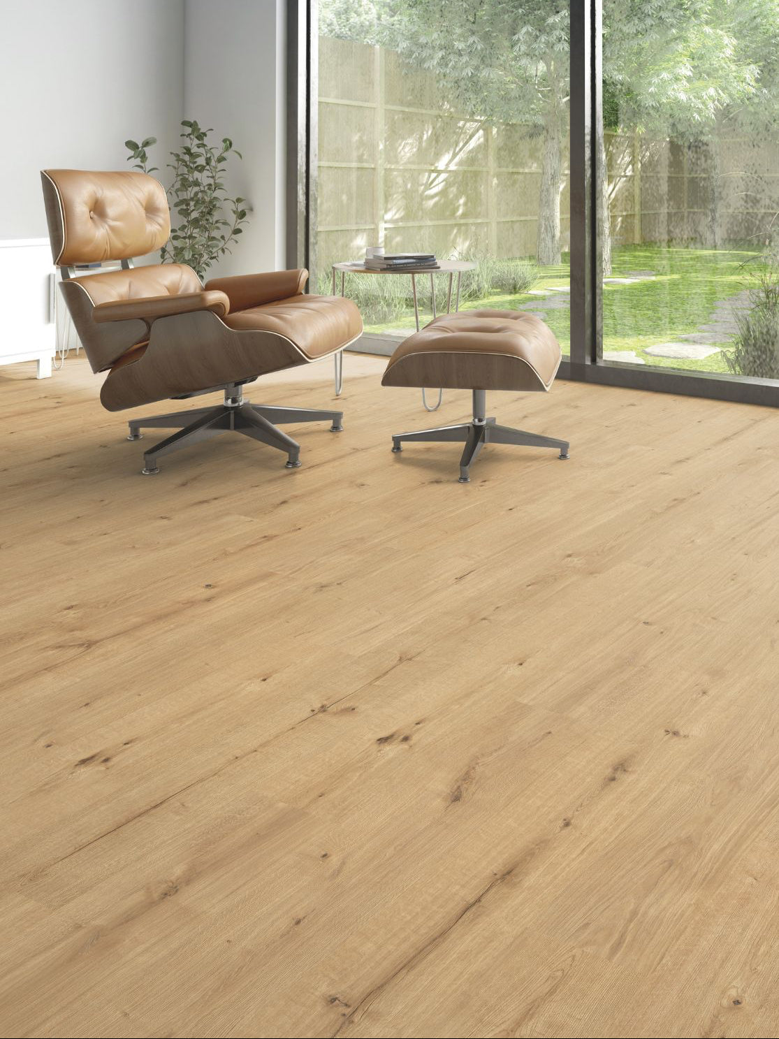 Lounge chair on engineered oak wide plank facing full-height garden glazing