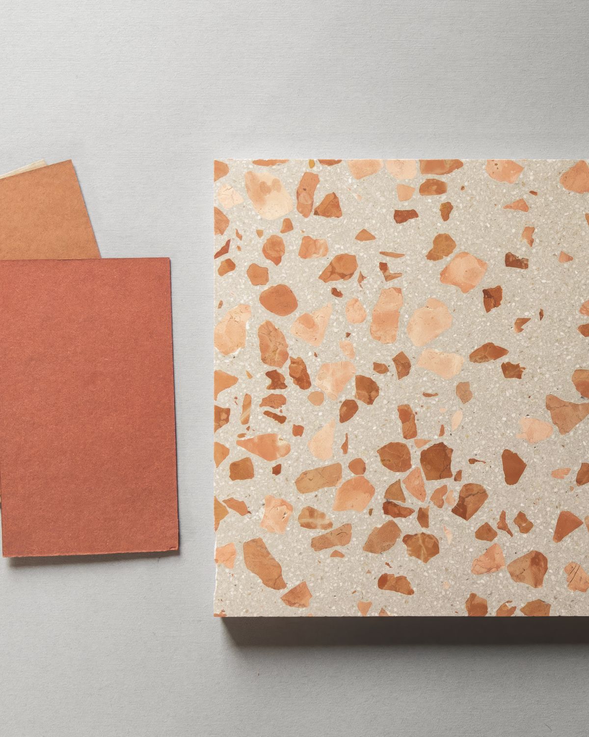 Notebook with terrazzo pattern and matching cover on a gray background