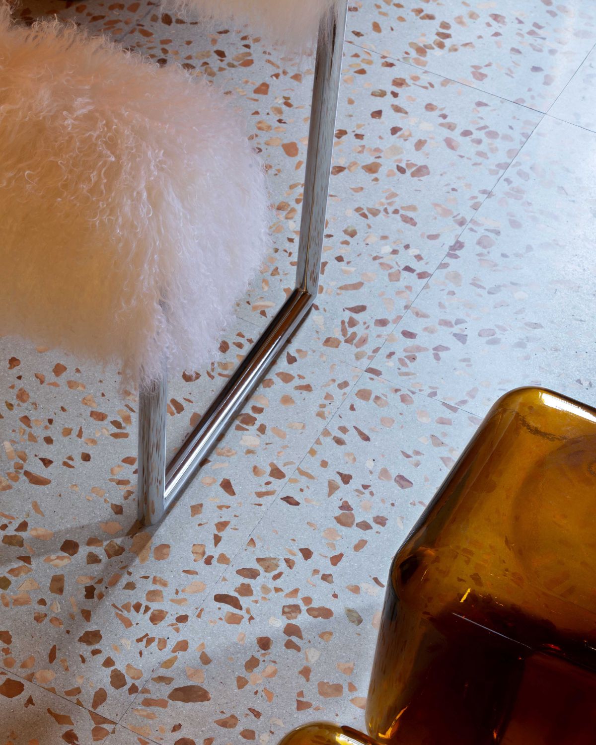 Close-up of a glass with a straw on a terrazzo countertop